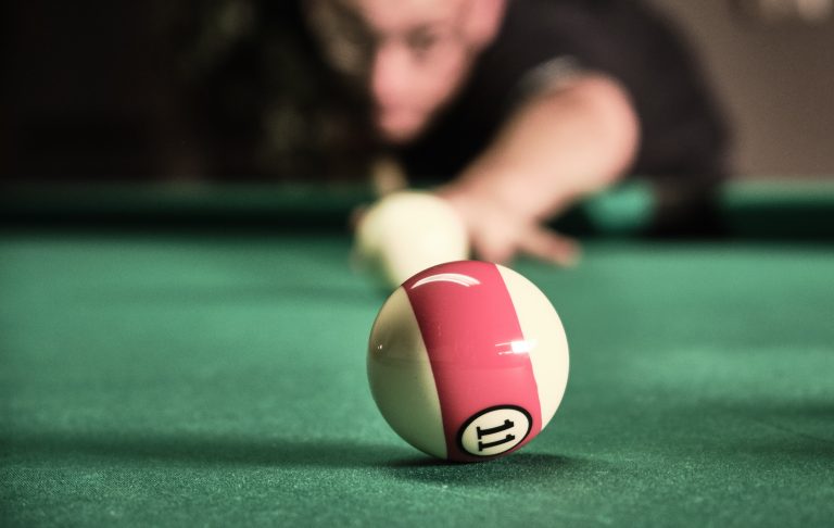 pool player aiming for a shot